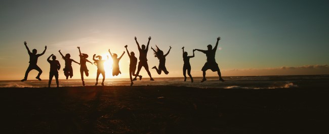 Cornish youth jumping at sunset
